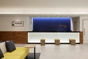 a waiting room with a large tv and a couch at Four Points Flex by Sheraton Kyoto Oike in Kyoto