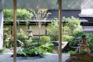 a japanese garden seen through a window at Four Points Flex by Sheraton Kyoto Oike in Kyoto