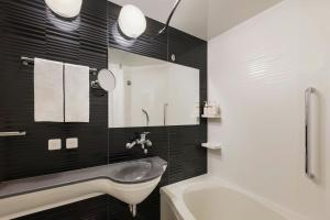 a bathroom with a sink and a mirror at Four Points Flex by Sheraton Kyoto Oike in Kyoto