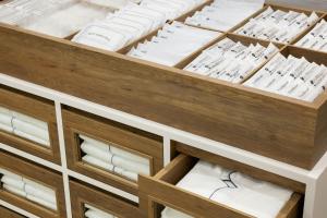 a drawer full of white linens in a cabinet at Four Points Flex by Sheraton Kyoto Oike in Kyoto
