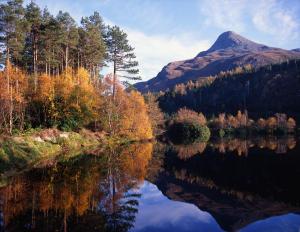 a view of a lake with a mountain in the background at The Glencoe Inn in Glencoe