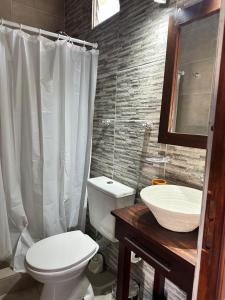 a bathroom with a white toilet and a sink at Las Gardenias in Mar del Plata +76 photos