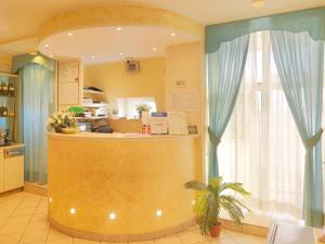 a restaurant with a counter in a kitchen at Hotel Arco Romana in Milan