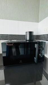 a pot sitting on top of a microwave at Vela House Songkhla in Songkhla +10 photos