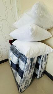 a stack of pillows sitting on top of a basket at Vela House Songkhla in Songkhla
