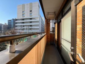 a balcony with a view of a building at Asakusa Hana hostel in Tokyo