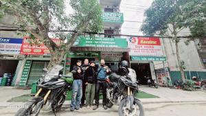 a group of people standing next to their motorcycles at Andy Hoang Riverside Hostel Bar Restaurant Music Beer & More in Ha Giang