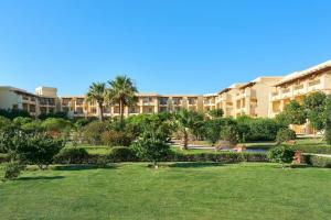 a park in front of a large apartment building at Sheraton Soma Bay Resort in Hurghada