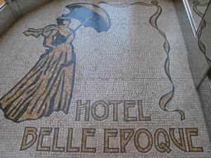 a tile floor with a picture of a woman holding an umbrella at Hotel Belle Epoque in Venice