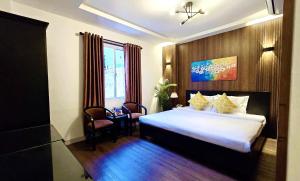 Giường trong phòng chung tại Rosa May Hotel