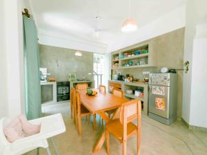 a kitchen with a wooden table and chairs in a room at Villa Ciana- Private apartment in Unawatuna