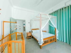 a bedroom with a canopy bed with a white canopy at Villa Ciana- Private apartment in Unawatuna