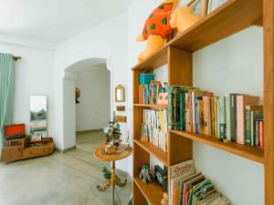 a room with shelves filled with books at Villa Ciana- Private apartment in Unawatuna +27 photos
