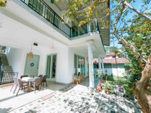 a home with a patio with a table and chairs at Villa Ciana- Private apartment in Unawatuna