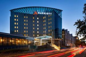 a marriott hotel with a sign on top of a building at London Marriott Hotel Kensington in London