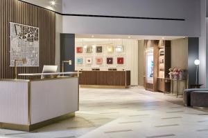 a lobby with a reception desk in a building at London Marriott Hotel Kensington in London