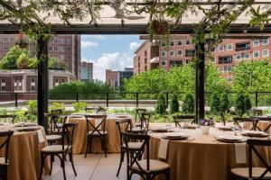 a room with tables and chairs with a view of a city at The Ritz-Carlton, St. Louis in Clayton