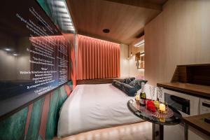 a small room with a bed and a table at Hotel CARA 大人専用Adult only hotel in Tokyo