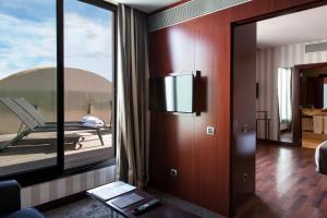 a room with a large glass door with a balcony at Zenit Valencia in Valencia