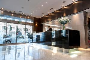 a man standing at the counter of a car dealership at Zenit Valencia in Valencia