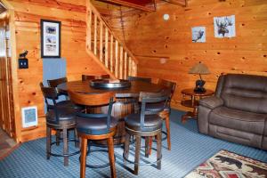 a dining room with a table and chairs and a couch at Cozy Bear Cabin Getaway in Island Park