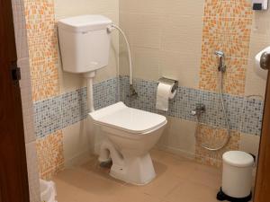 a bathroom with a toilet and a shower at Zipp Lite - HAL Old Airport Road in Bangalore