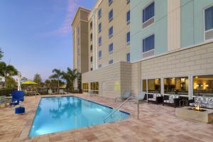 a swimming pool in front of a hotel at TownePlace Suites by Marriott Naples in Naples