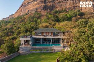 an aerial view of a house with a mountain at StayVista's Esperanza - Mountain-Side Retreat with Infinity Pool, Jacuzzi, Gazebo & Indoor-Outdoor Activities in Lonavala