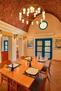 a dining room with a large wooden table and chairs at Sheraton Miramar Resort El Gouna in Hurghada