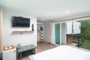 a bedroom with a bed and a tv on a wall at Aob Khao Resort and Camping in Ban Pa Lau