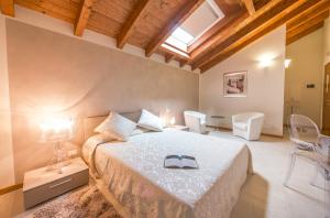 a bedroom with a bed with a book on it at Agriturismo Ca' La Pergola in Verona