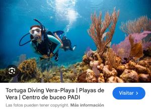 a person in the ocean taking a picture of a reef at Precioso y luminoso apartamento junto al mar y playa en Garrucha 1A in Garrucha