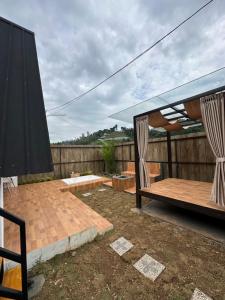 a patio with a bed and a canopy at Glamping triangle riyadhi 2 in Panjadakan
