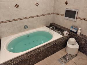 a bath tub in a bathroom with a tv at パティオ山梨 - 大人専用 - in Fuefuki