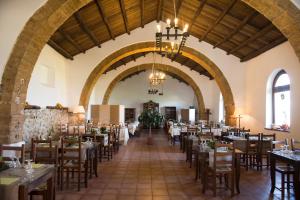a dining room with tables and chairs in a building at Agriturismo Fratelli Sanacore in Rilievo