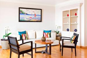 a living room with a white couch and chairs at Sheraton Rhodes Resort in Ixia