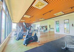 a gym with treadmills and exercise bikes in it at Cozy Urban Retreat in Emira, Mall Next Door #EM1 in Shah Alam
