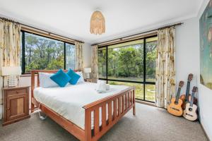 a bedroom with a bed and some windows at Narrow Neck Retreat in Katoomba +53 photos