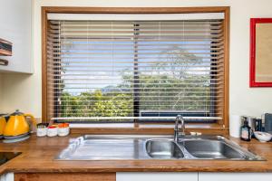 a kitchen counter with a sink and a window at Narrow Neck Retreat in Katoomba