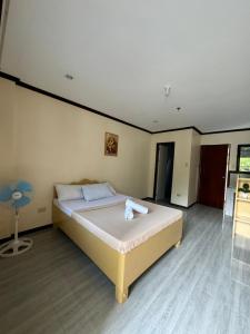 a bedroom with a large bed in a room at J&K Sunrise in El Nido