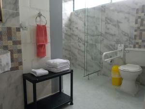 a bathroom with a toilet and a glass shower at Finca San Miguel Filandia in Filandia +31 photos