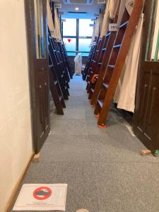 a hallway of a library with a sign on the floor at Hostel Lodging Tokyo Ueno in Tokyo