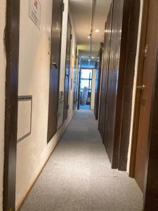 a hallway of an office building with a long corridor at Hostel Lodging Tokyo Ueno in Tokyo +46 photos