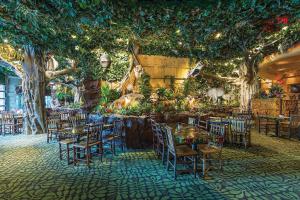a restaurant with tables and chairs and trees at Sheraton Niagara Falls in Niagara Falls