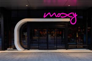 a neon sign on the front of a store at Moxy Atlanta Midtown in Atlanta