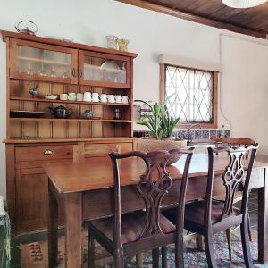 a dining room with a wooden table and chairs at The Writer's House in Bedford