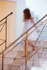 a woman is walking down the stairs of a building at Aegean Plaza Hotel in Kamari