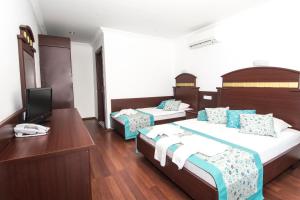 Postel nebo postele na pokoji v ubytování Sunberk Hotel