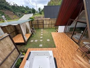 a view of a backyard with a deck and a tub at Glamping triangle riyadi 1 in Panjadakan +4 photos