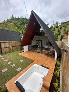 a house with a swimming pool on a wooden deck at Glamping triangle riyadi 1 in Panjadakan